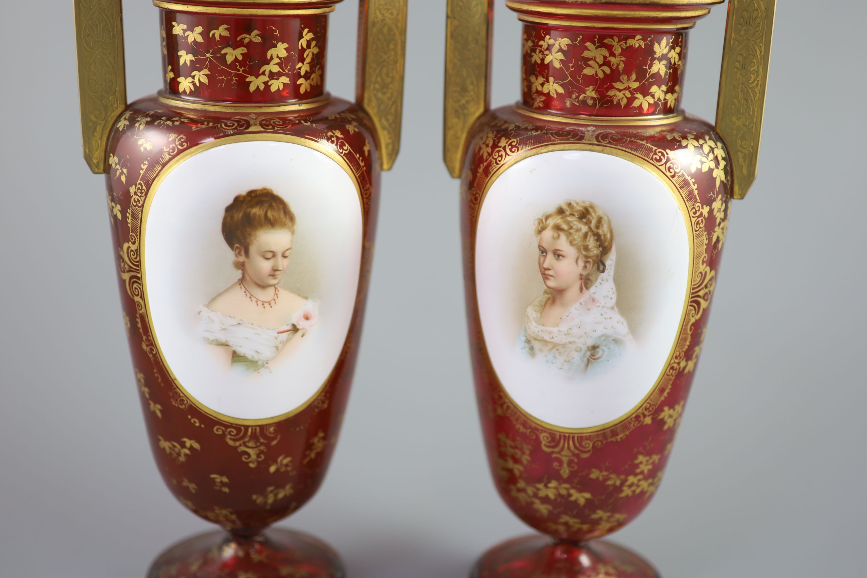 A pair of Bohemian gilt decorated ruby glass two handled vases, late 19th century, height 32cm